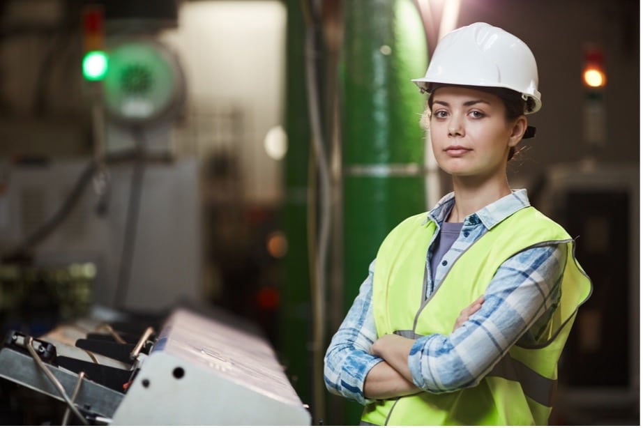 A person wearing a safety vest and a hard hat
