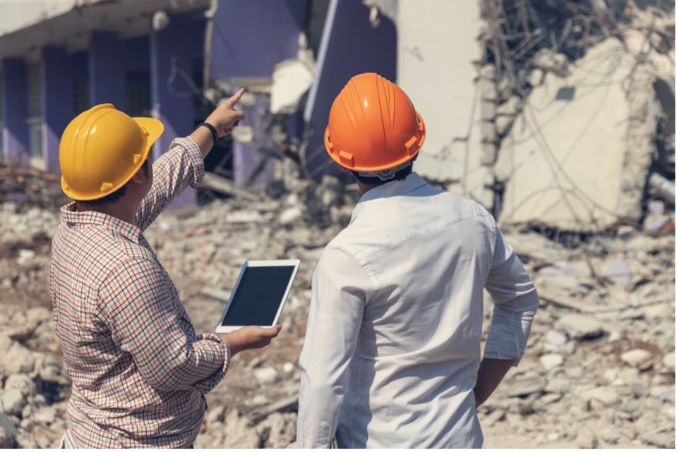 A couple of men wearing hard hats